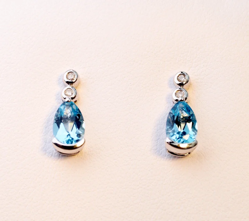 Ladies Earrings with Square Spark-14K white gold post earrings with pear-shaped Blue Topaz drops