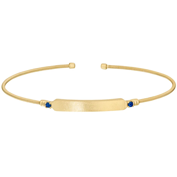 Ladies woodland whisper bracelets -Gold Finish Sterling Silver Cable Cuff Bracelet with Name Plate and Simulated Blue Sapphire Birth Gems - September